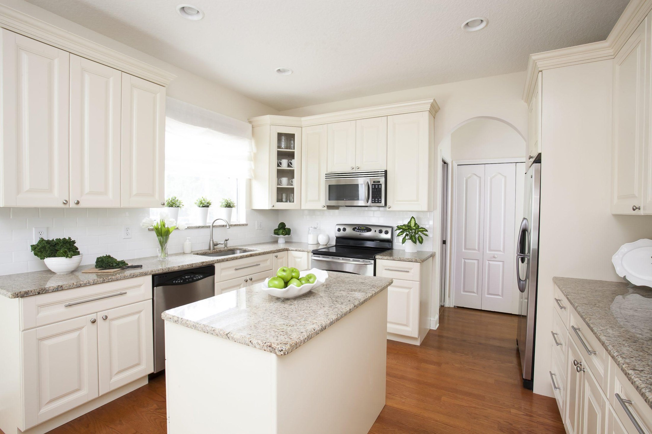 Elegant white shaker kitchen with warm finished details